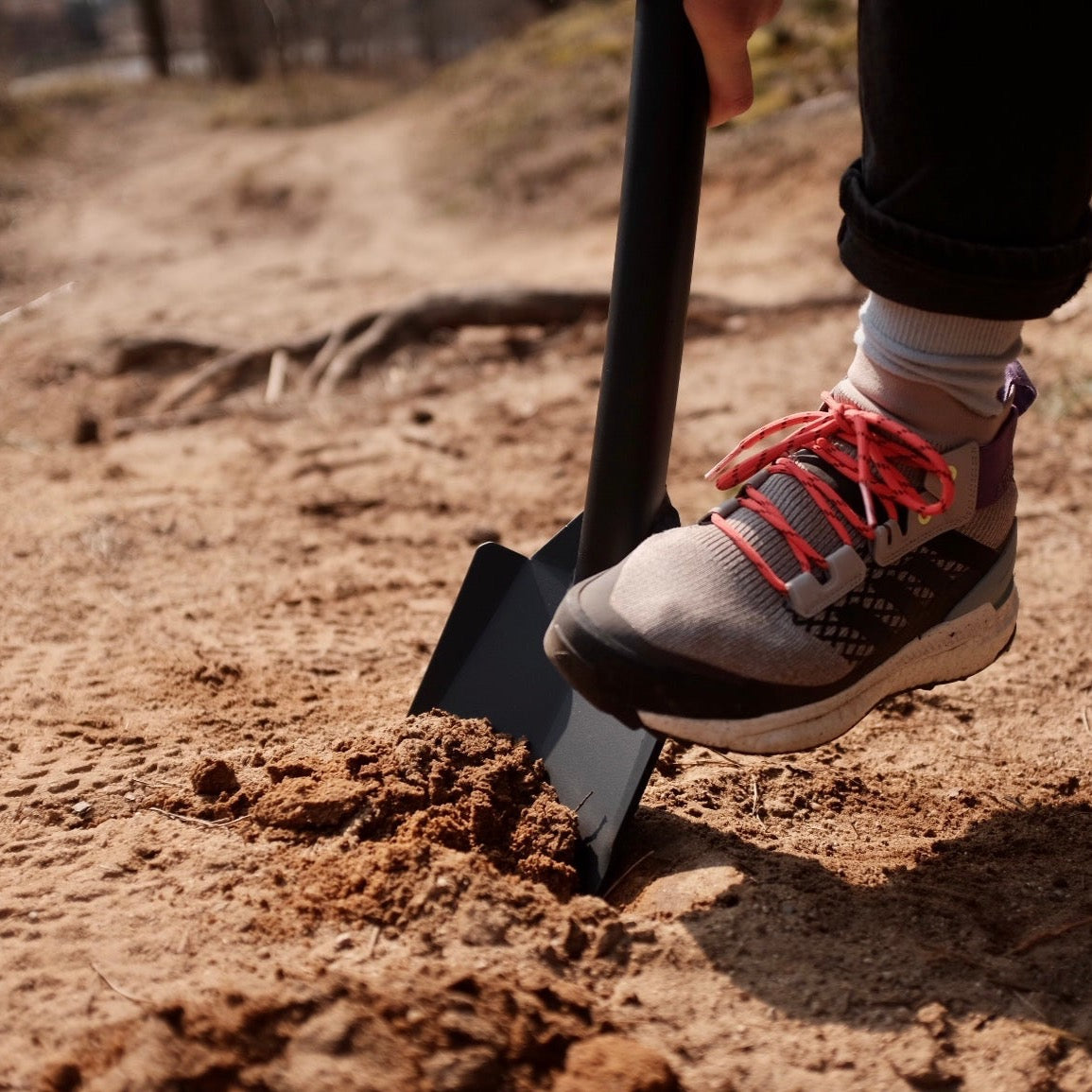 Black DOT shovel digging in the sand