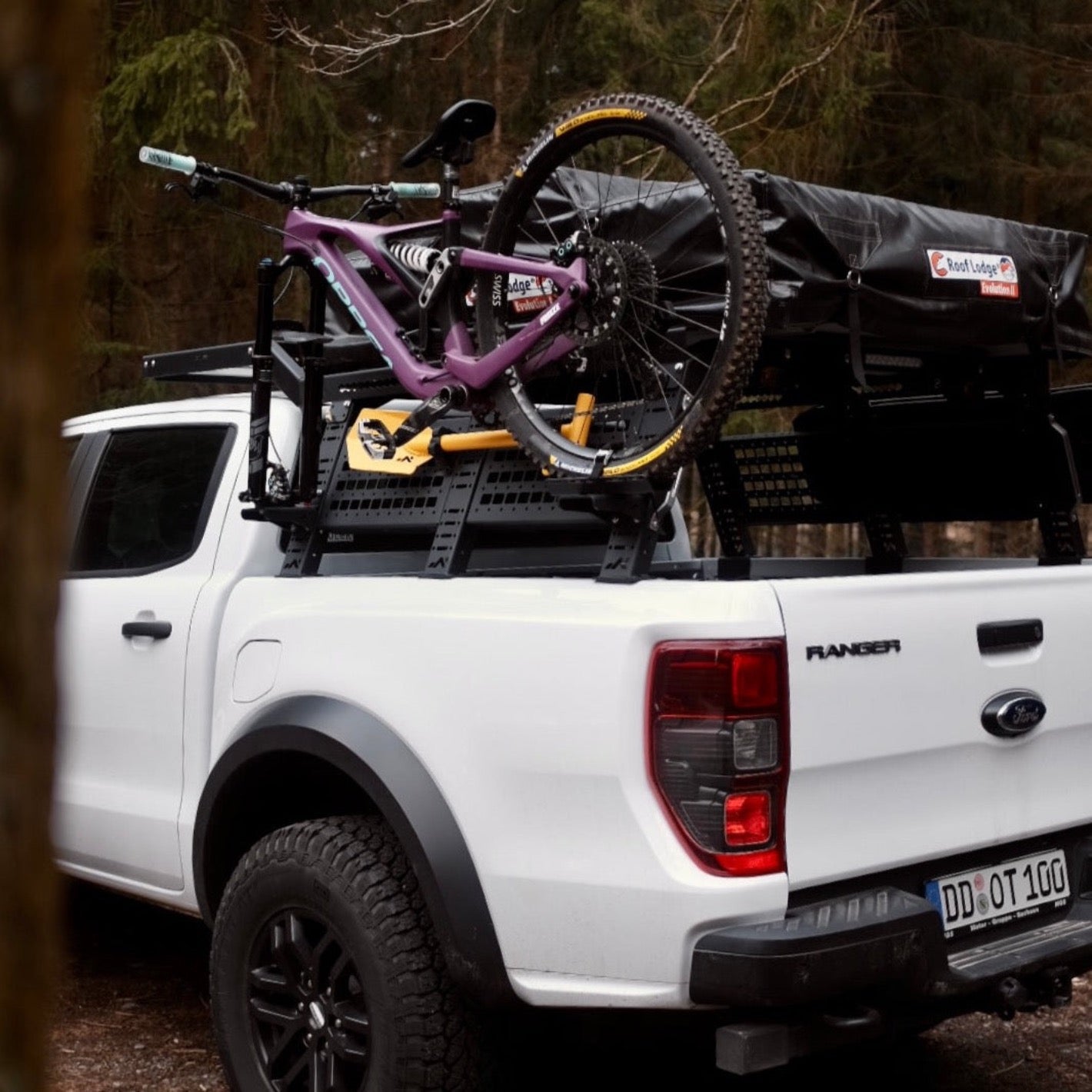 Violett Orbea bicycle mounted on white Ford Ranger Raptor
