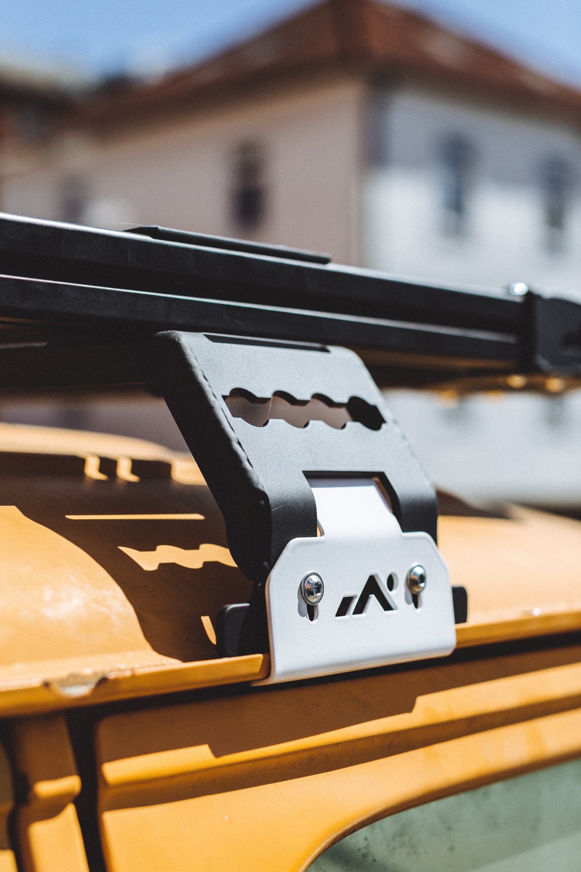 DOT Roof rack mount with white clamp on yellow van to assemble extrusion bars for camping and outdoor equipment