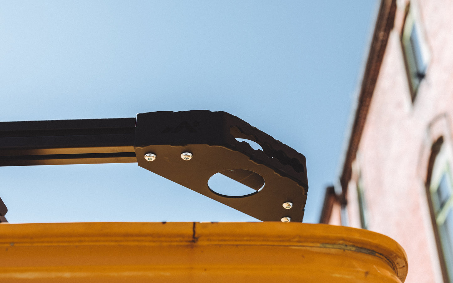 Assembled black DOT Corner Bracket on yellow GMC van