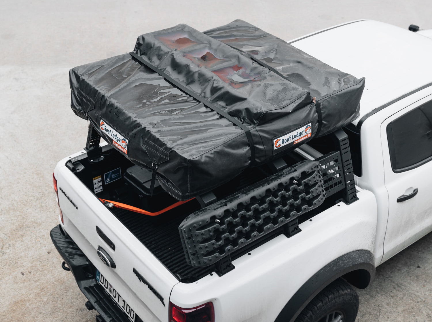 Top view of DOT bed rack with roof tent and molle panel on white Ford Pick Up