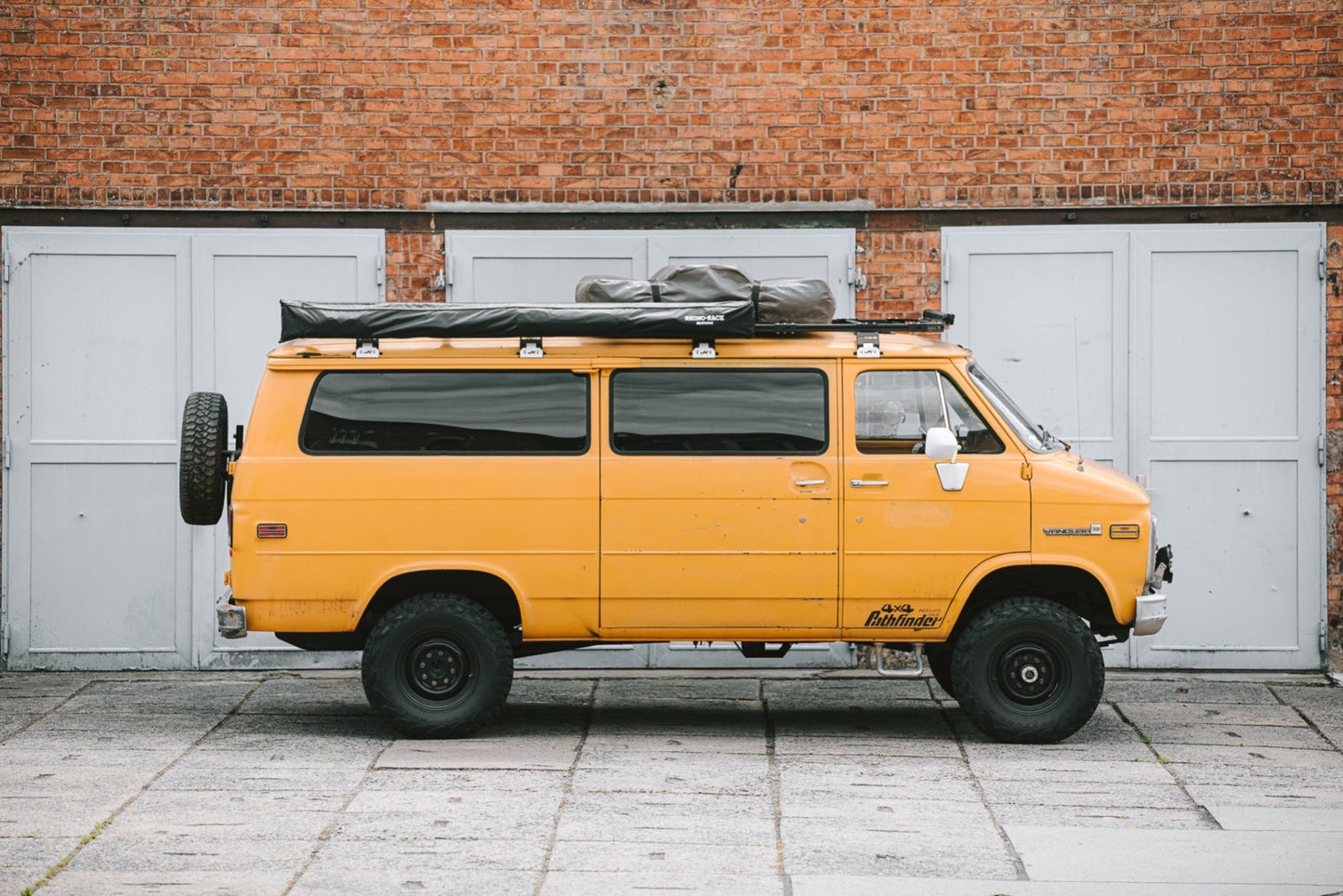 Yellow GMC Van with roof tent and roof rack
