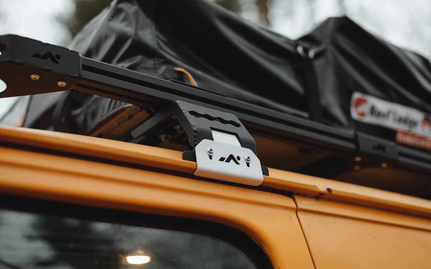 DOT roof rack mount assembled on a gutter of a yellow van