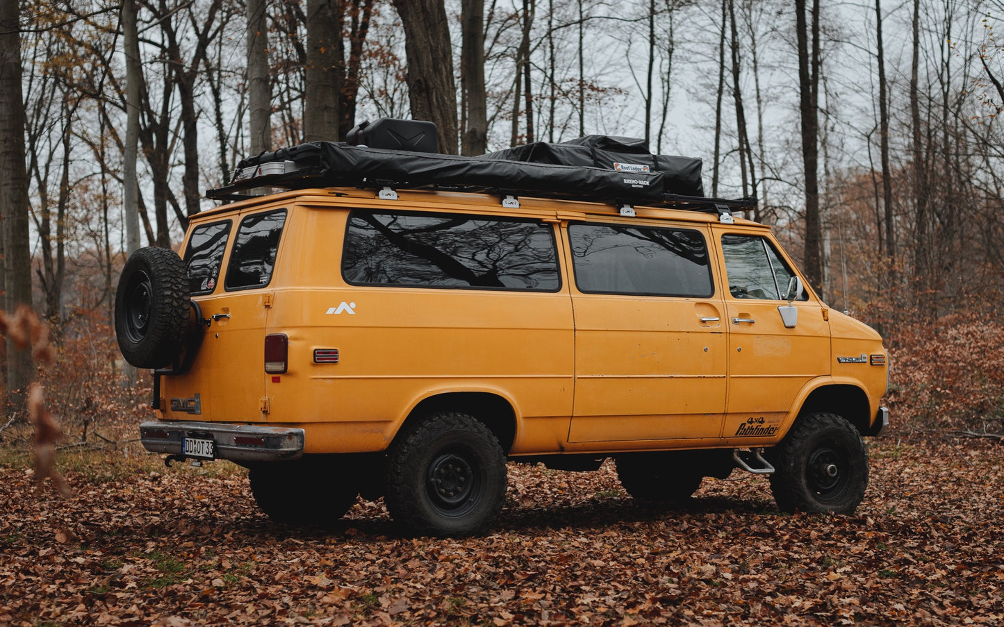 Yellow GMC Van standing in the forrest